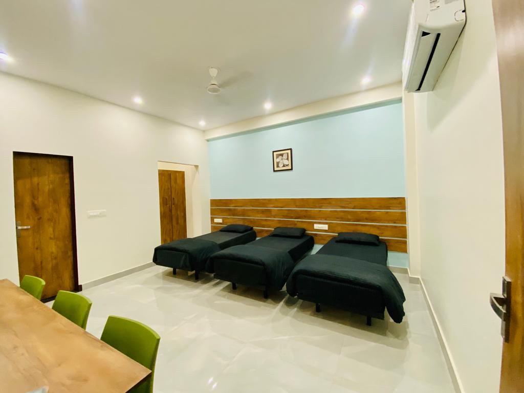 Triple sharing AC room with individual study tables at Anand Luxury Girls Home, Jagatpura (photo 2)