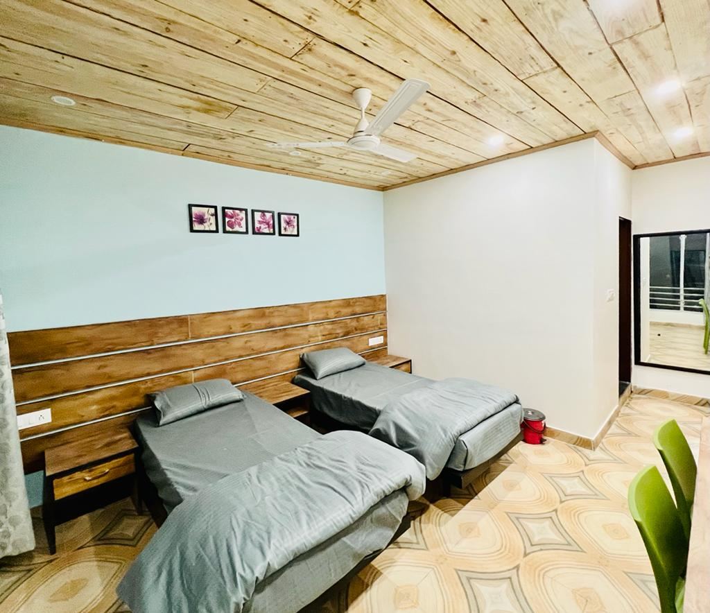 Twin sharing AC room with 8-inch mattresses at Anand Luxury Girls Home, Jagatpura
