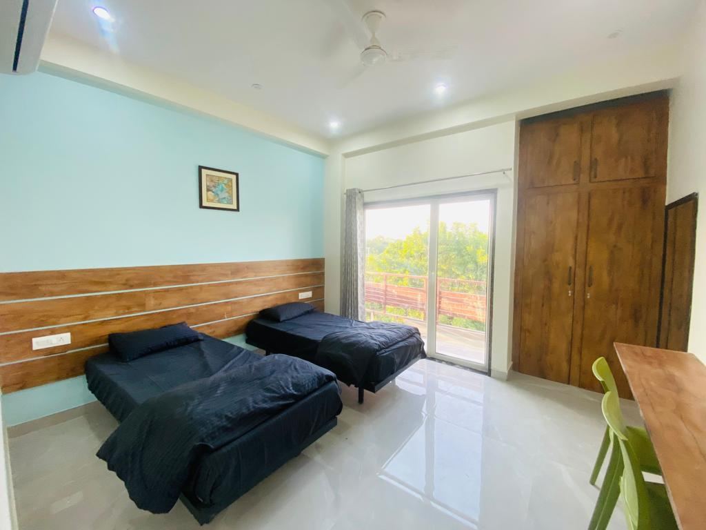 Twin sharing AC room with 8-inch mattresses at Anand Luxury Girls Home, Jagatpura (photo 5)