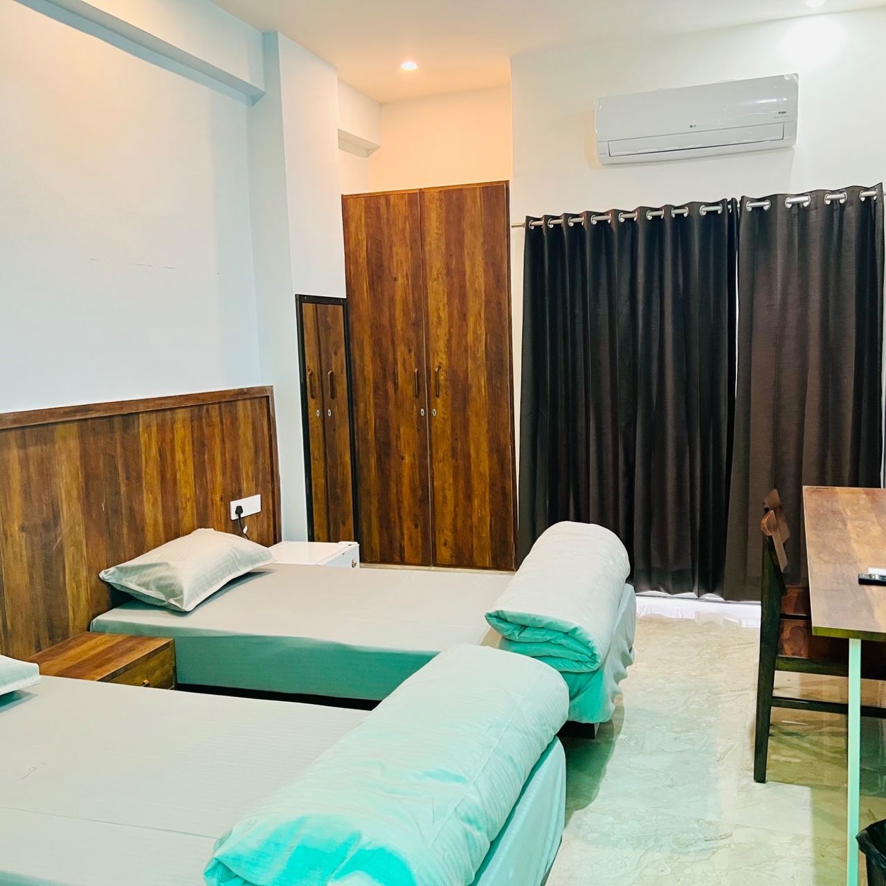 Bright AC room with wooden headboard at Karol's Villa Girls PG, Malviya Nagar